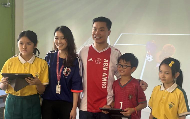 Doodle Cup event day: staff, students and parents in front of the projected pitch